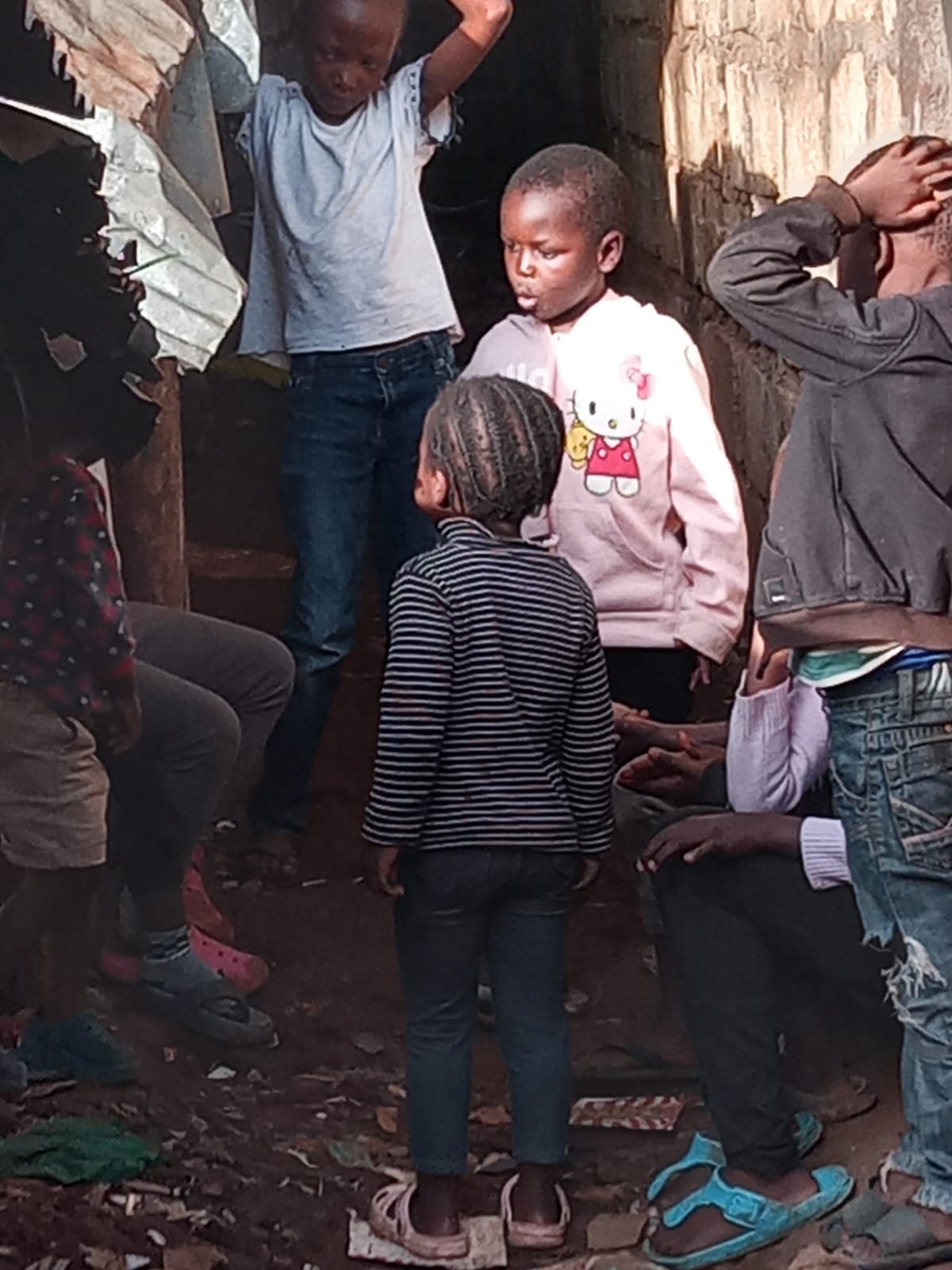 Children gathered together in a small community space in Kibera
